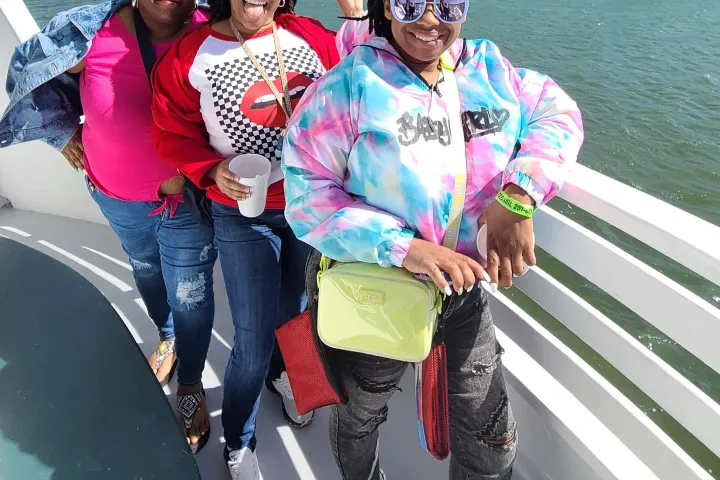 a group of people posing for the camera on a boat