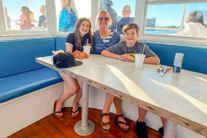 a group of people sitting at a table in a boat