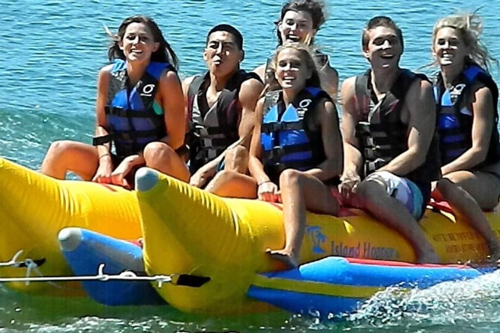 a group of people on a banana boat in the water
