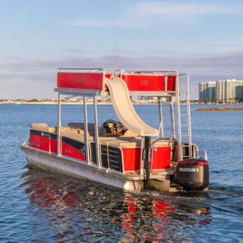 a pontoon boat with a slide in the water