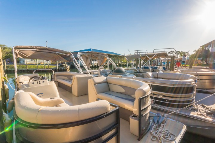 a group of pontoon boats docked in the water