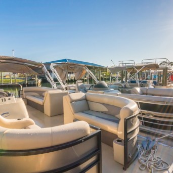 a group of pontoon boats docked in a body of water