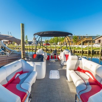 a pontoon boat docked in a body of water